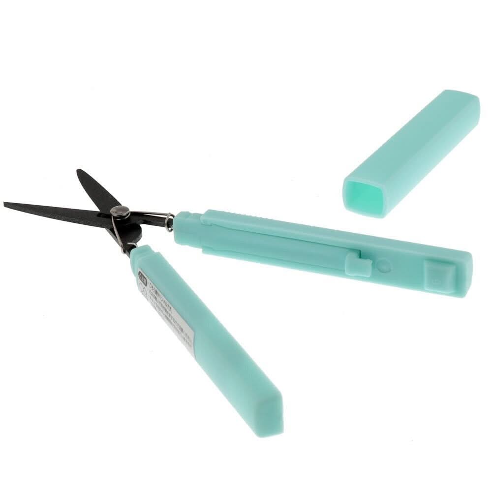 Angled view of Sun-Star Akeruno Stickyle scissors in turquoise, opened with turquoise cap removed.