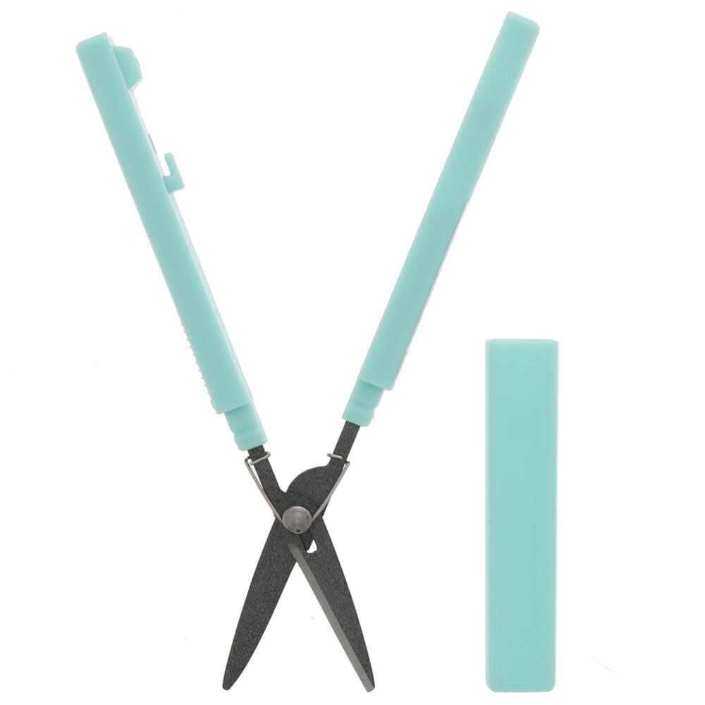 Sun-Star Akeruno Stickyle turquoise scissors fully opened, with protective cap placed beside.