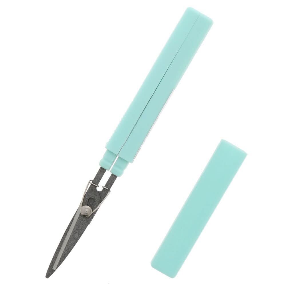 Sun-Star Akeruno Stickyle turquoise scissors partially opened, with cap placed beside.