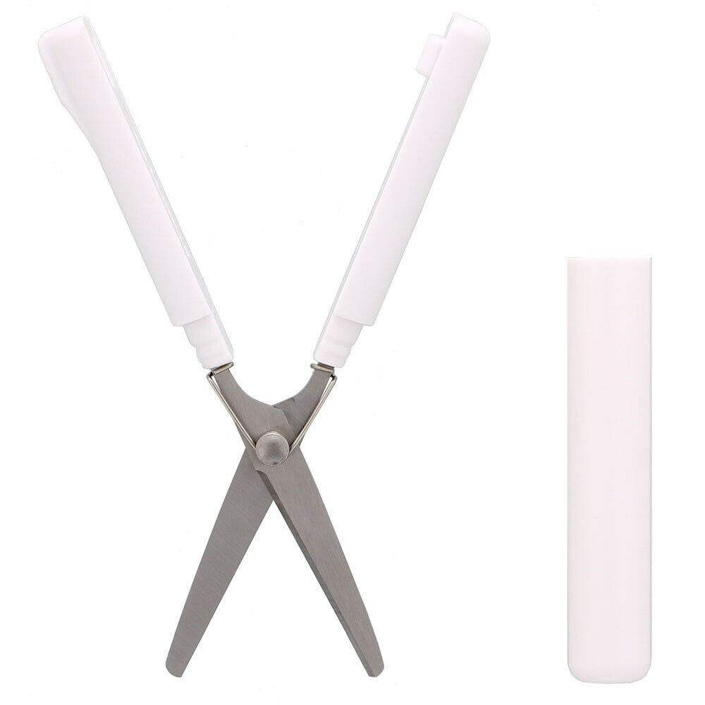 Sun-Star Stickyle compact scissors in white, opened with protective cap placed beside.