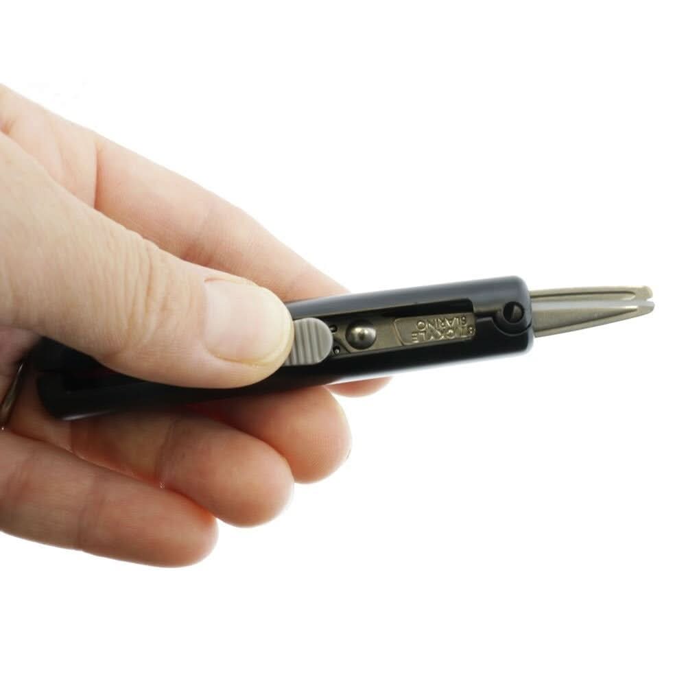 Sun-Star Stickyle Slarino black retractable compact scissors held in hand, showing sliding mechanism.