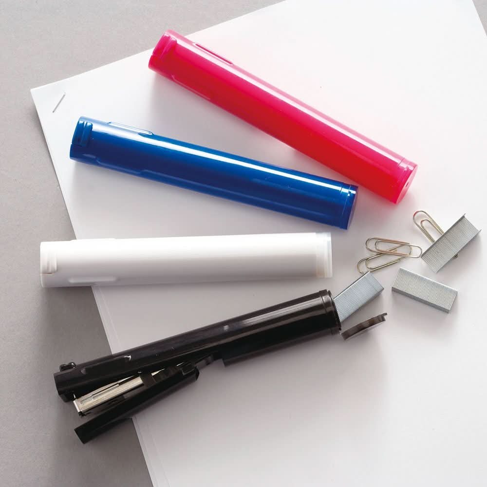 Assorted Sun-Star Stickyle staplers in black, blue, red, and white, shown with paper clips, staples, and documents.