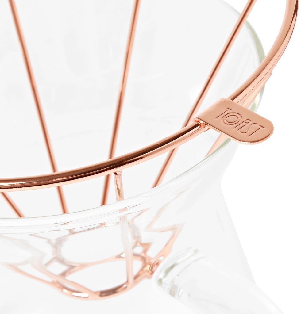 Close-up of the Toast Living H.A.N.D metal dripper showing its rose-gold wire construction.