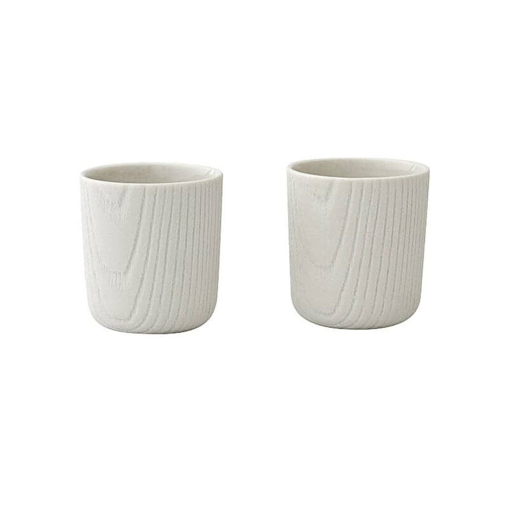Set of two Toast Living MU mini cups, 80ml, in white porcelain with a subtle wood-grain textured finish.