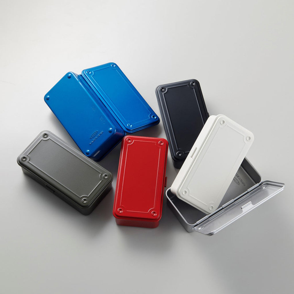 Top view of TOYO STEEL T-190 toolboxes in classic colours including blue, red, white, black, grey, and silver, arranged in a circular layout.