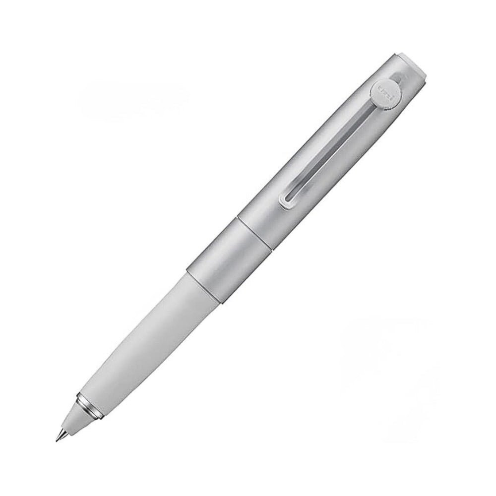 The Journal Shop - Angled close-up of the Uni-Ball ZENTO Signature Model 0.38mm Ballpoint Pen, highlighting its sleek silver body and precise pen tip.