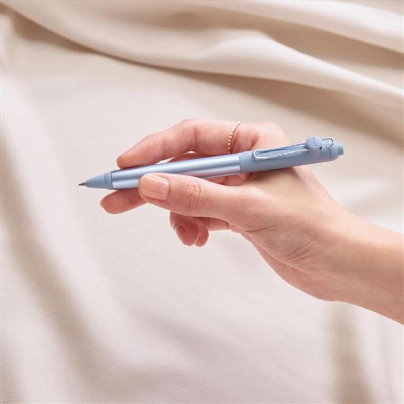 The Journal Shop - Uni-Ball ZENTO Signature Model 0.38mm ballpoint pen shown in hand while writing.