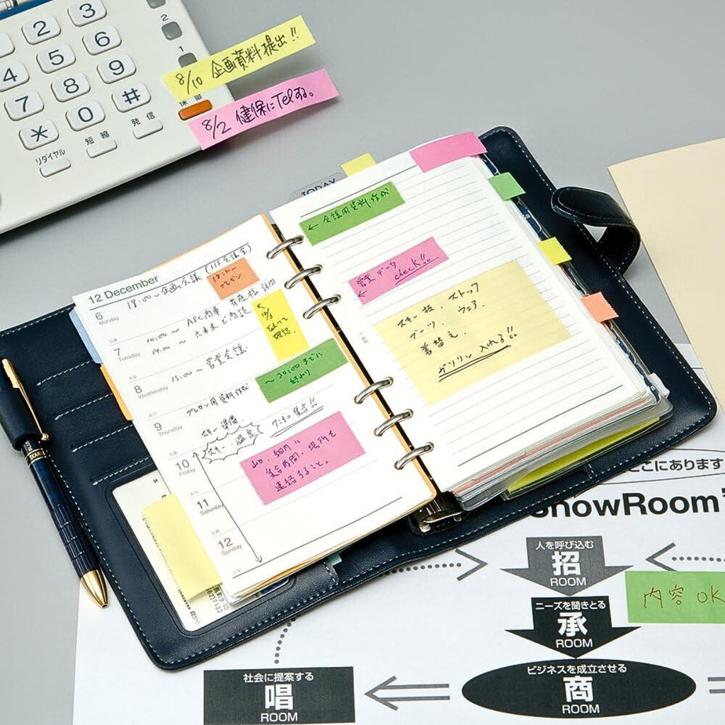 Yamato tape dispenser used to label a planner with pink and yellow adhesive strips