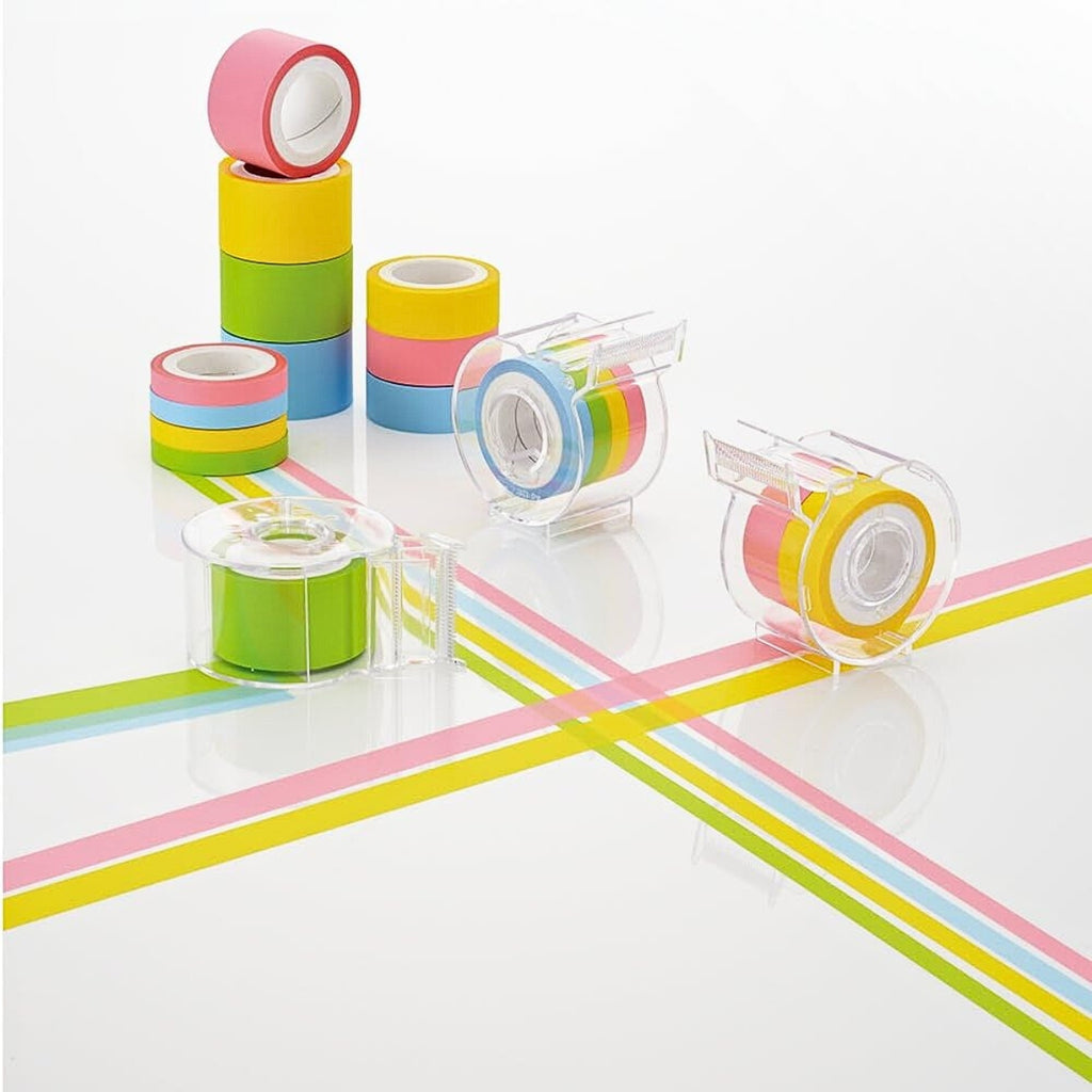 Four-colour Yamato film tapes arranged with the clear dispenser, showing bright neon shades.