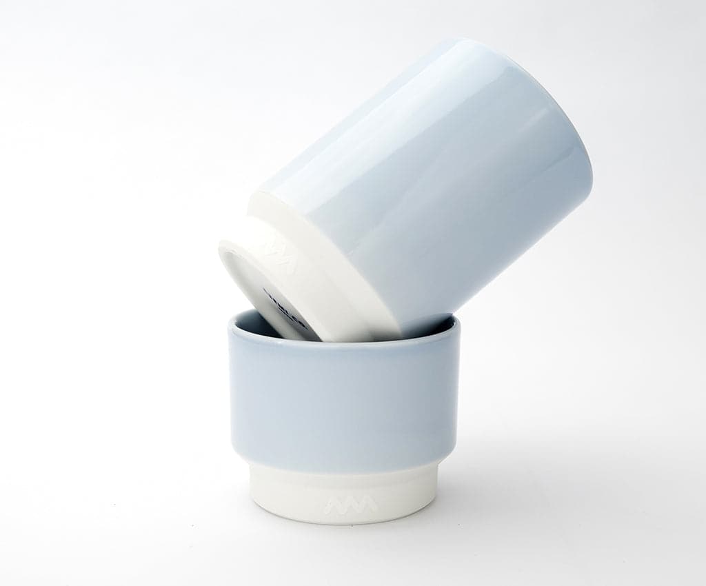 Two Asemi Hasami large cups in light blue stacked together, showing the soft glazed exterior and white base.