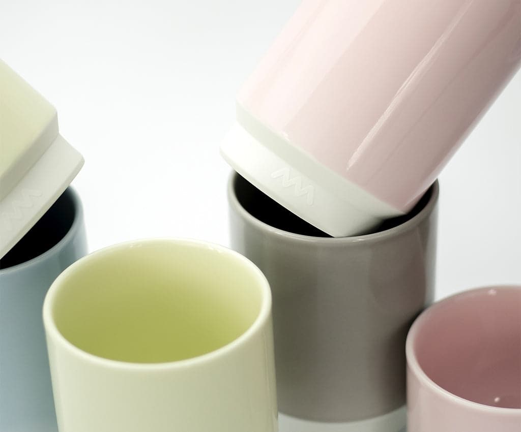 Asemi Hasami small cups in light grey shown with other colour variants, highlighting the glazed interiors.