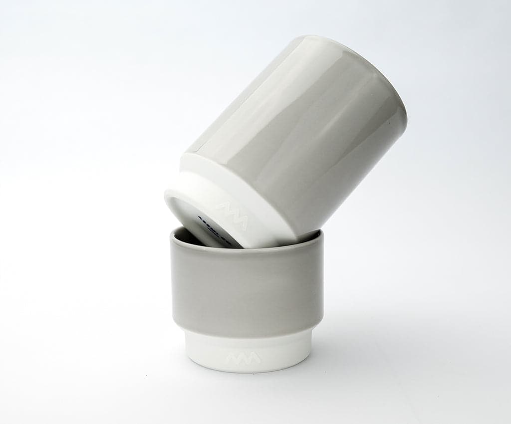 Two Asemi Hasami small cups in light grey stacked together, showing the soft glazed exterior and white base.